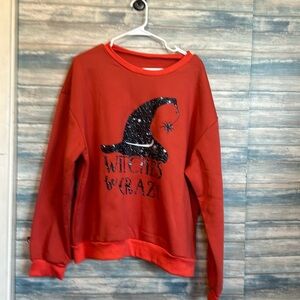 Burnt orange sweatshirt with witches hat in black